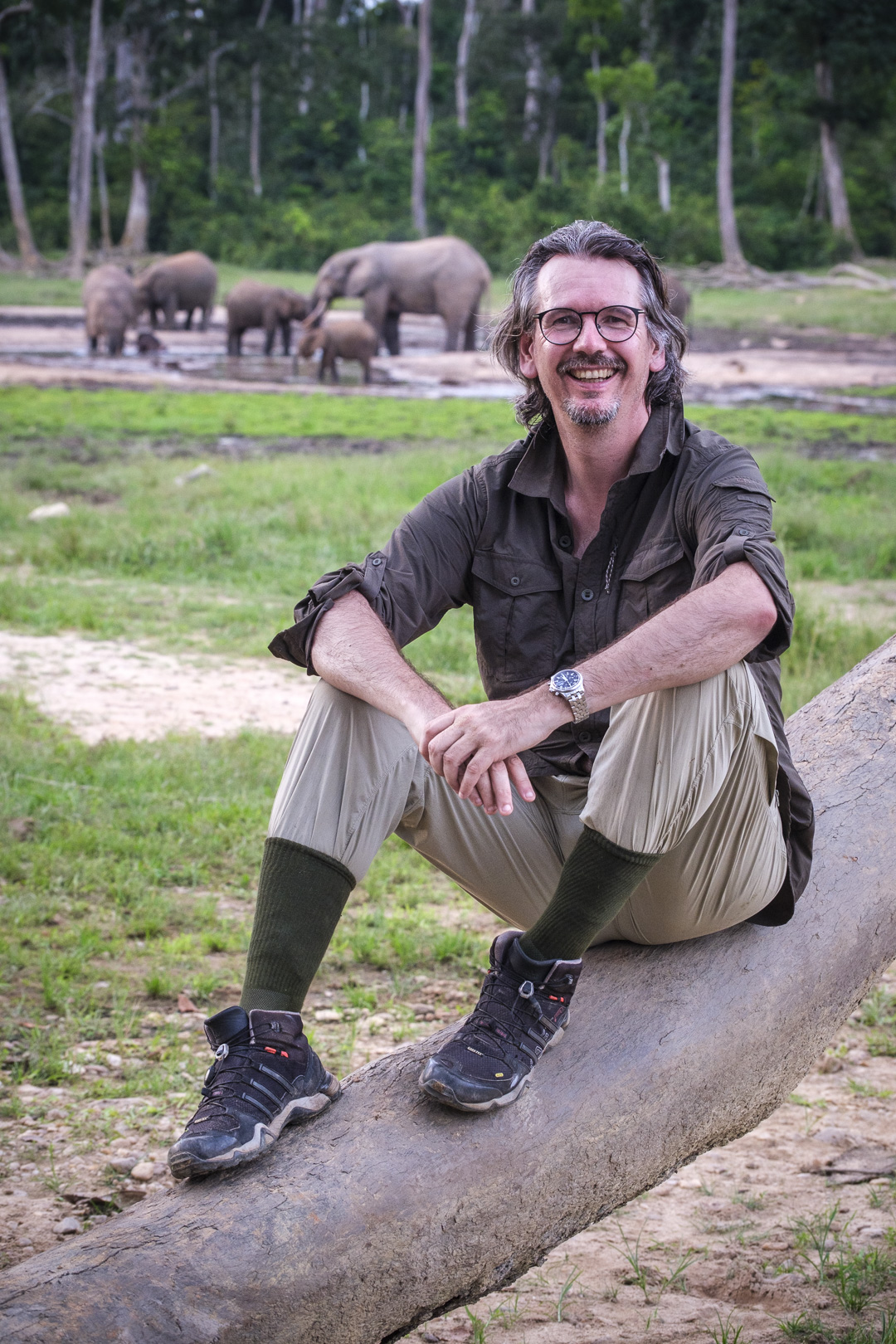 Thorsten Mehret travelling in Central Africa, with forest elephants in the background